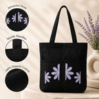 Suryatra Lavender Daisy Noir Canvas Tote Bag for Women & Men | Premium Cotton Canvas Shoulder Bag with Dual Front Pockets | Tote Bag for Office, College, Shopping & Travel | Black | 14 x 16 Inches