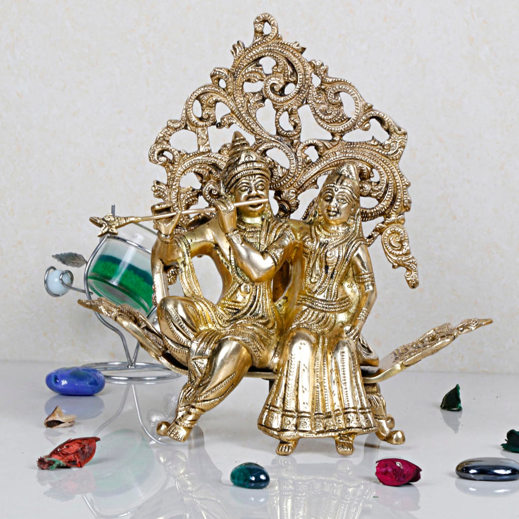 ARTVARKO Brass Radha Krishna Sitting on Couch Kalpvriksha Tree Love Couple Showpiece Idol for Home Décor Living Room Pooja Mandir Gift Item 24 cm