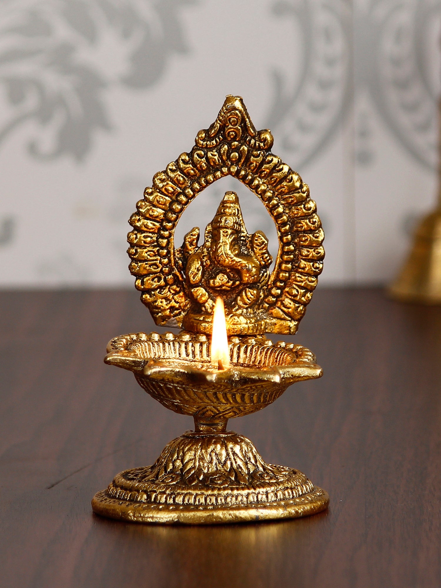 Lord Ganesha Idol with Diya Handcrafted Golden Metal Showpiece Kafalo
