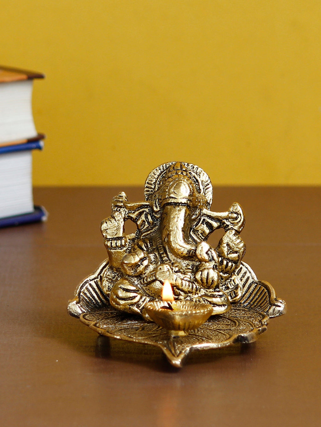 Golden Metal Handcrafted Lord Ganesha Idol with Diya on Leaf Kafalo