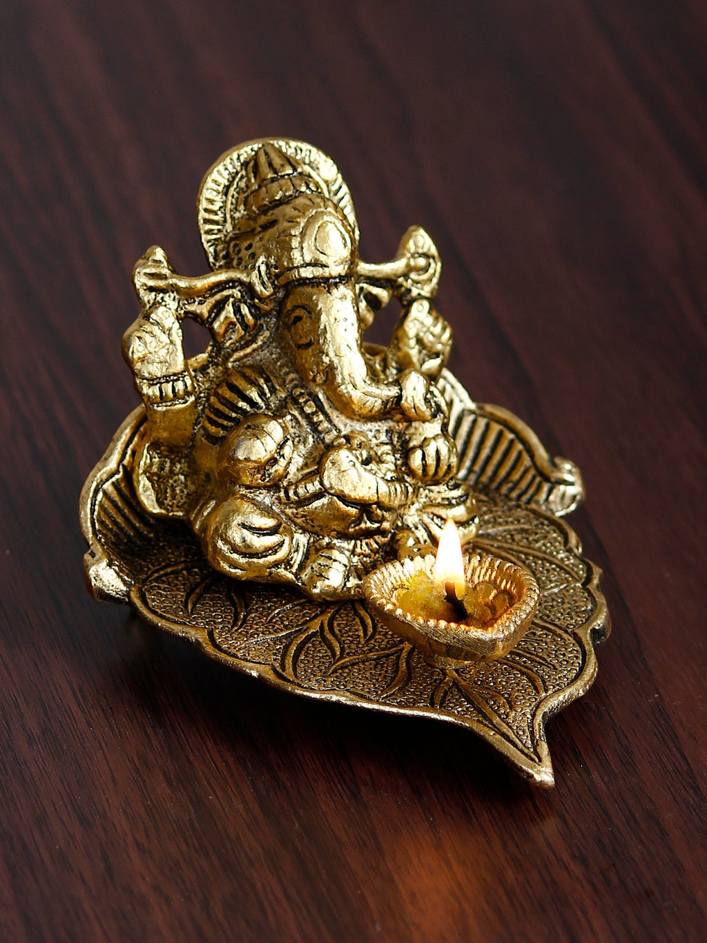 Golden Metal Handcrafted Lord Ganesha Idol with Diya on Leaf Kafalo