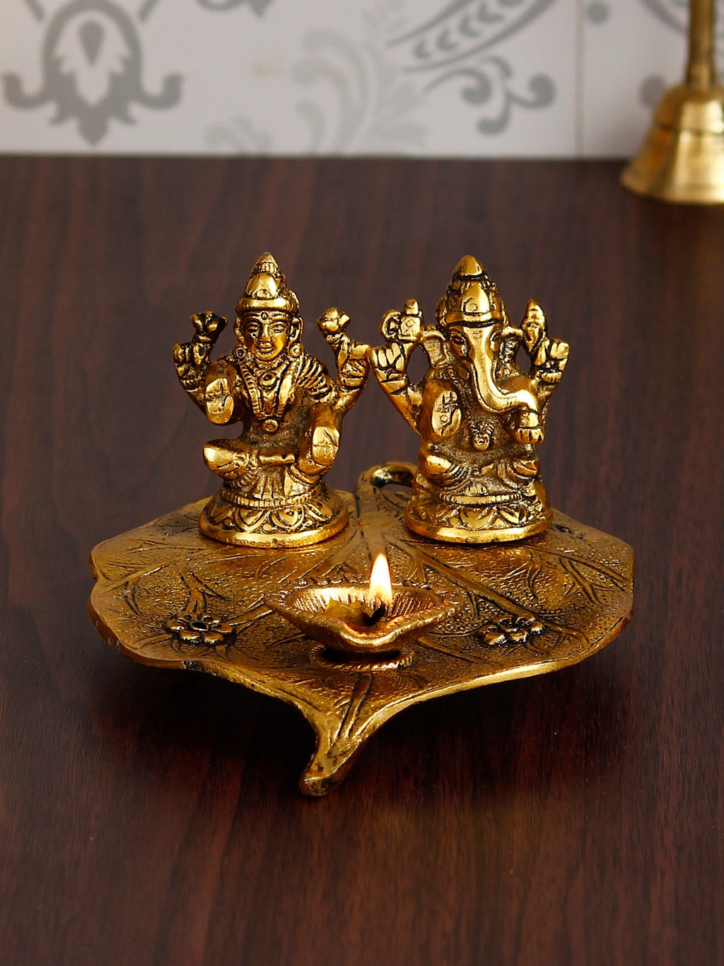 Golden Metal Handcrafted Laxmi Ganesha Idols with Diya on Leaf Kafalo
