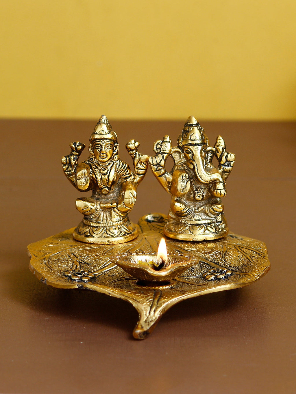 Golden Metal Handcrafted Laxmi Ganesha Idols with Diya on Leaf Kafalo