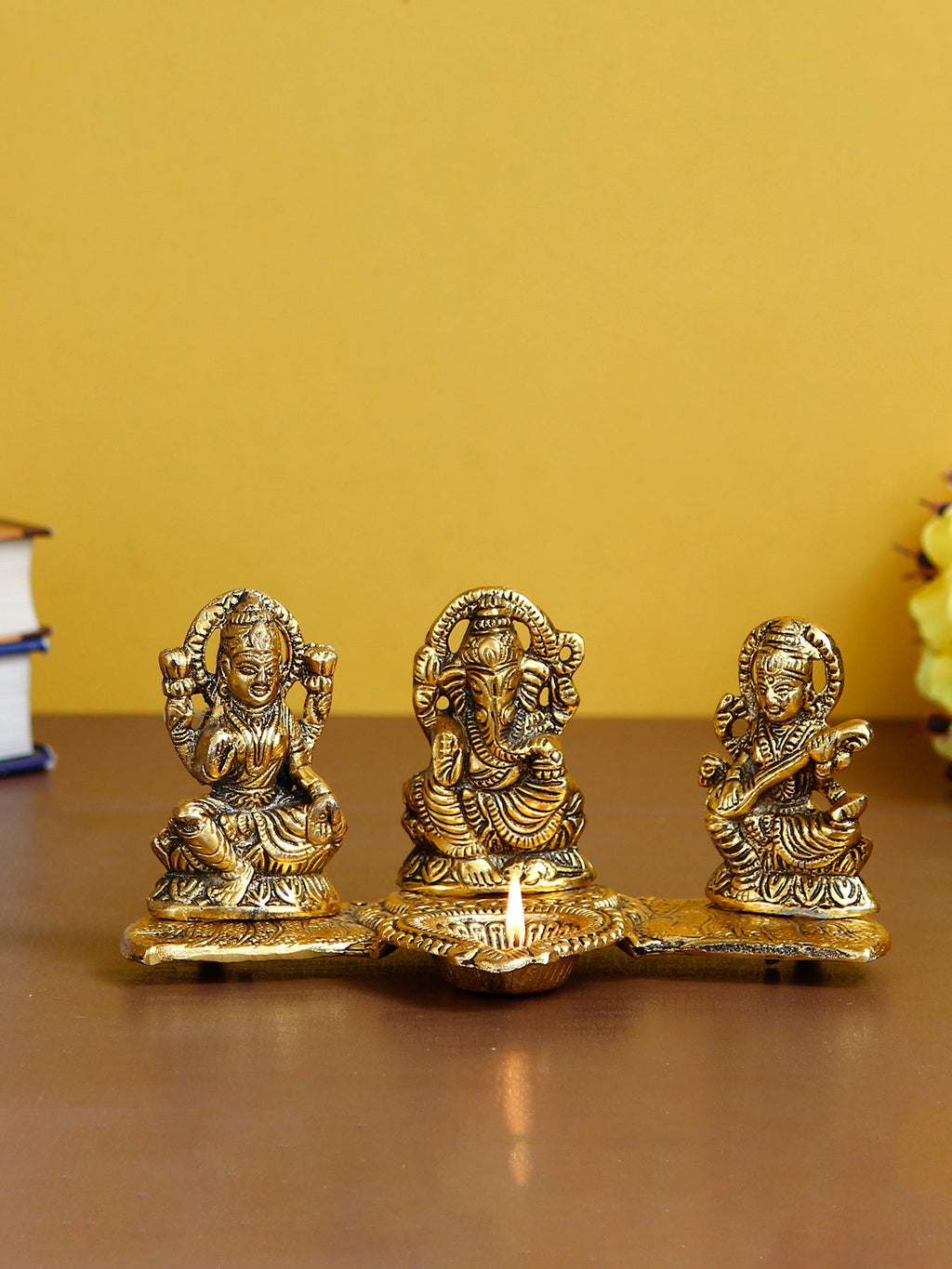 Gold Metal Handcrafted Laxmi Ganesha Saraswati Idols with Diya on Leaf Chowki Kafalo