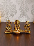 Gold Metal Handcrafted Laxmi Ganesha Saraswati Idols with Diya on Leaf Chowki Kafalo