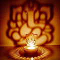 Metal Golden Lord Ganesha tea light candle holder that cast shadows Kafalo