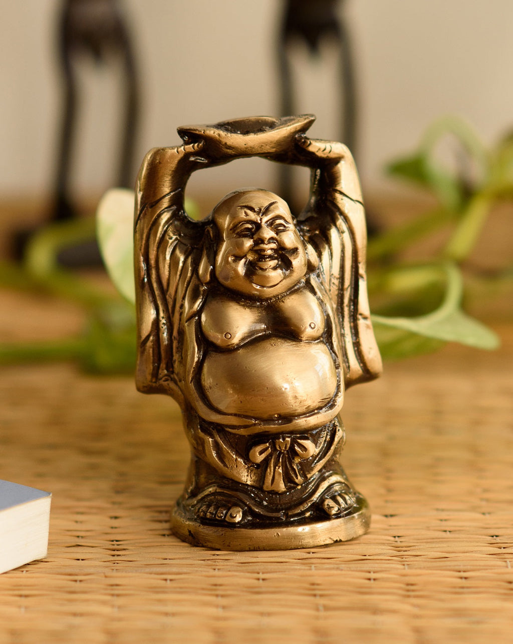 Standing Laughing buddha statue holding a gold ingot, with his hands upright Kafalo