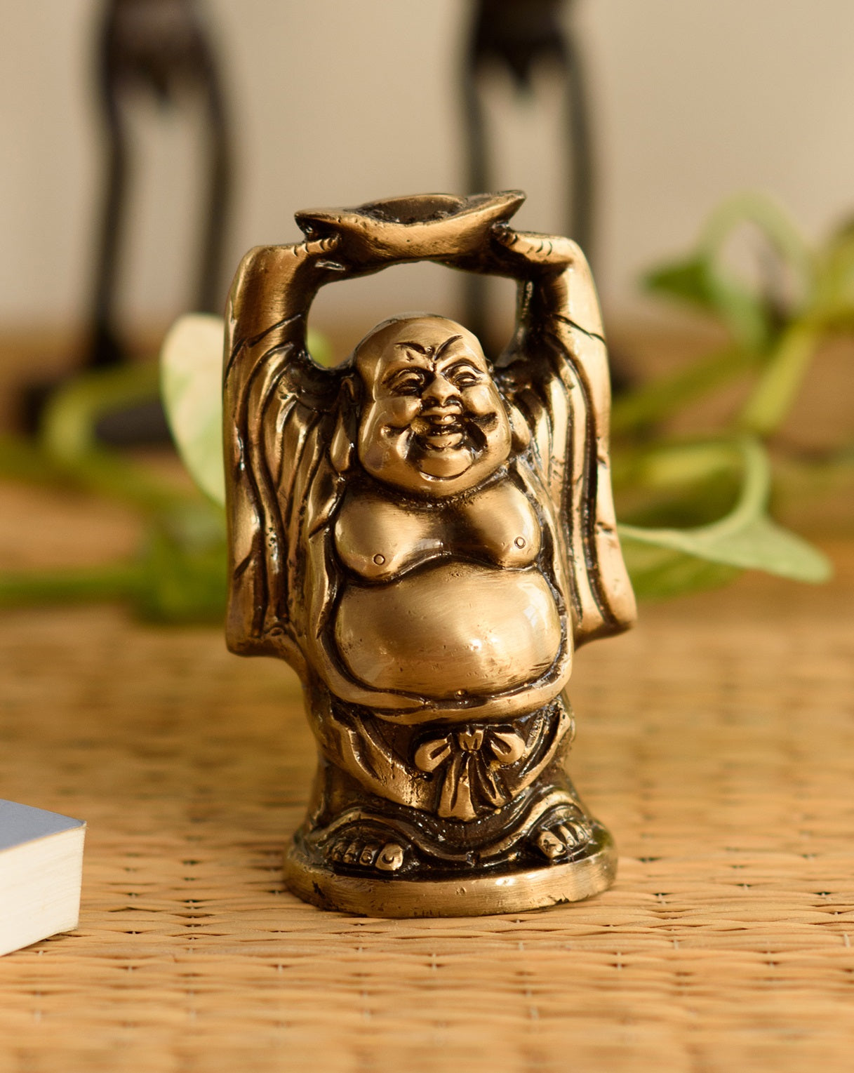 Standing Laughing buddha statue holding a gold ingot, with his hands upright Kafalo