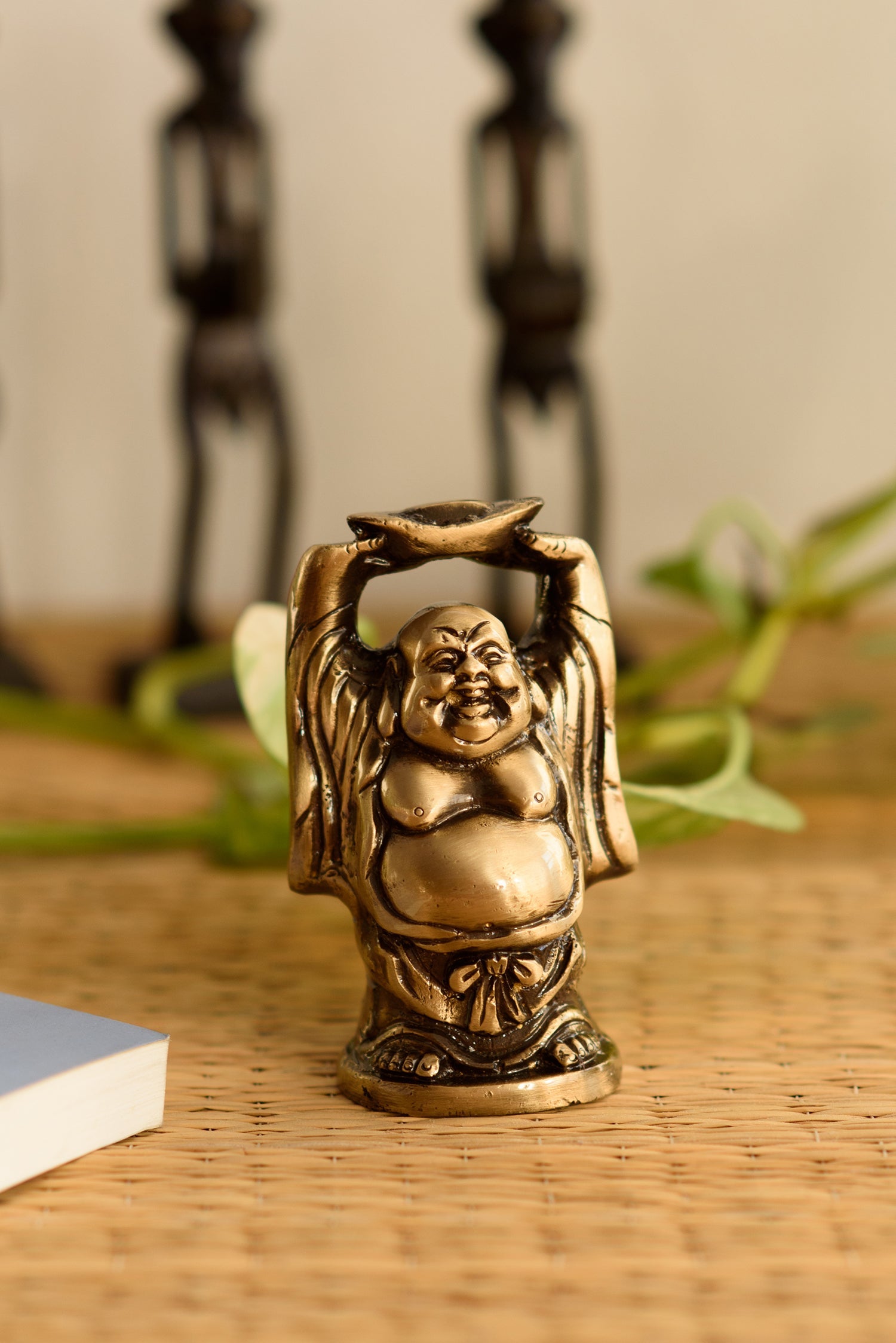 Standing Laughing buddha statue holding a gold ingot, with his hands upright Kafalo