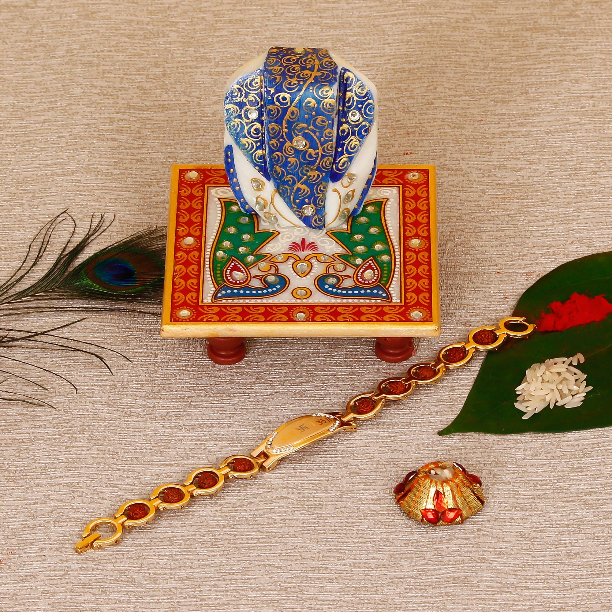 Designer Bracelet Religious Rakhi with Lord Ganesha on Marble Chowki and Roli Tikka Matki Kafalo