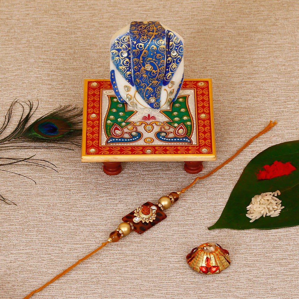 Stone Rudraksh Rakhi with Lord Ganesha on Marble Chowki and Roli Tikka Matki Kafalo