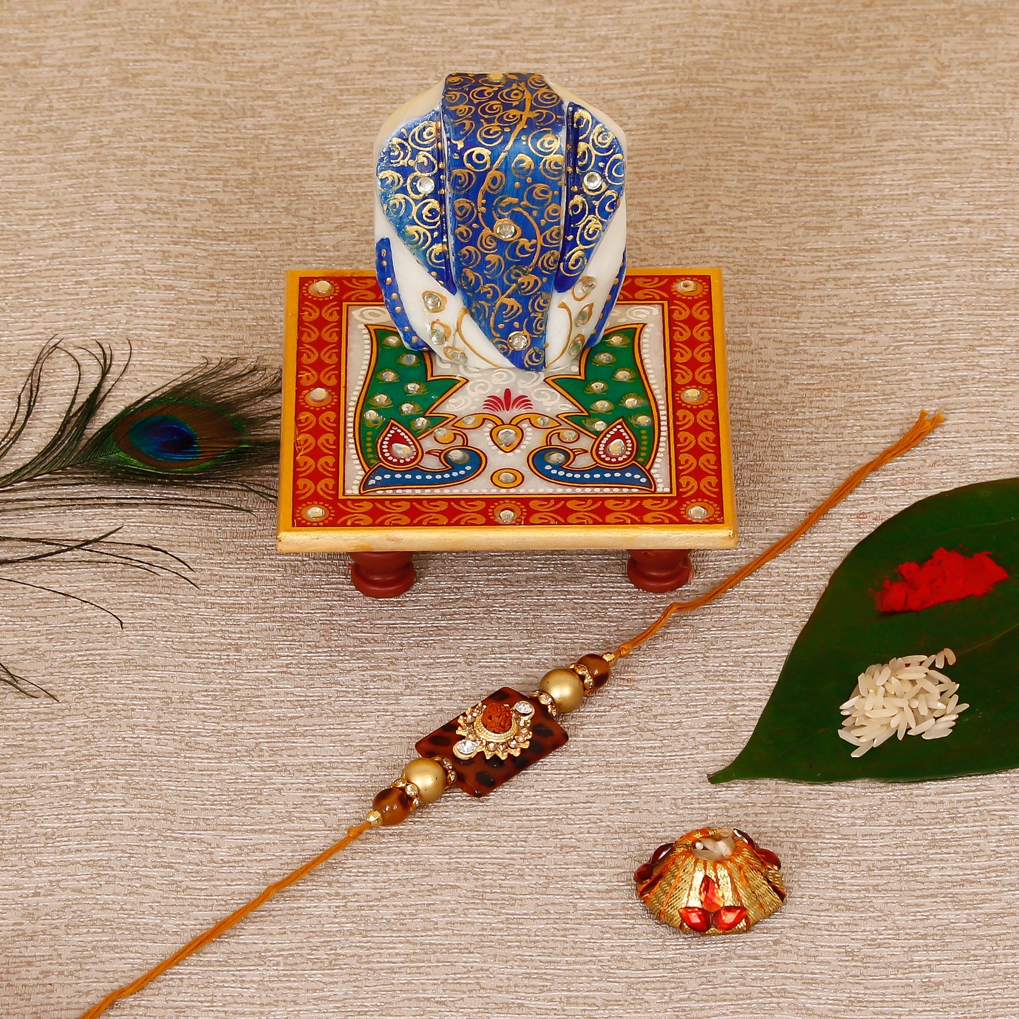 Stone Rudraksh Rakhi with Lord Ganesha on Marble Chowki and Roli Tikka Matki Kafalo
