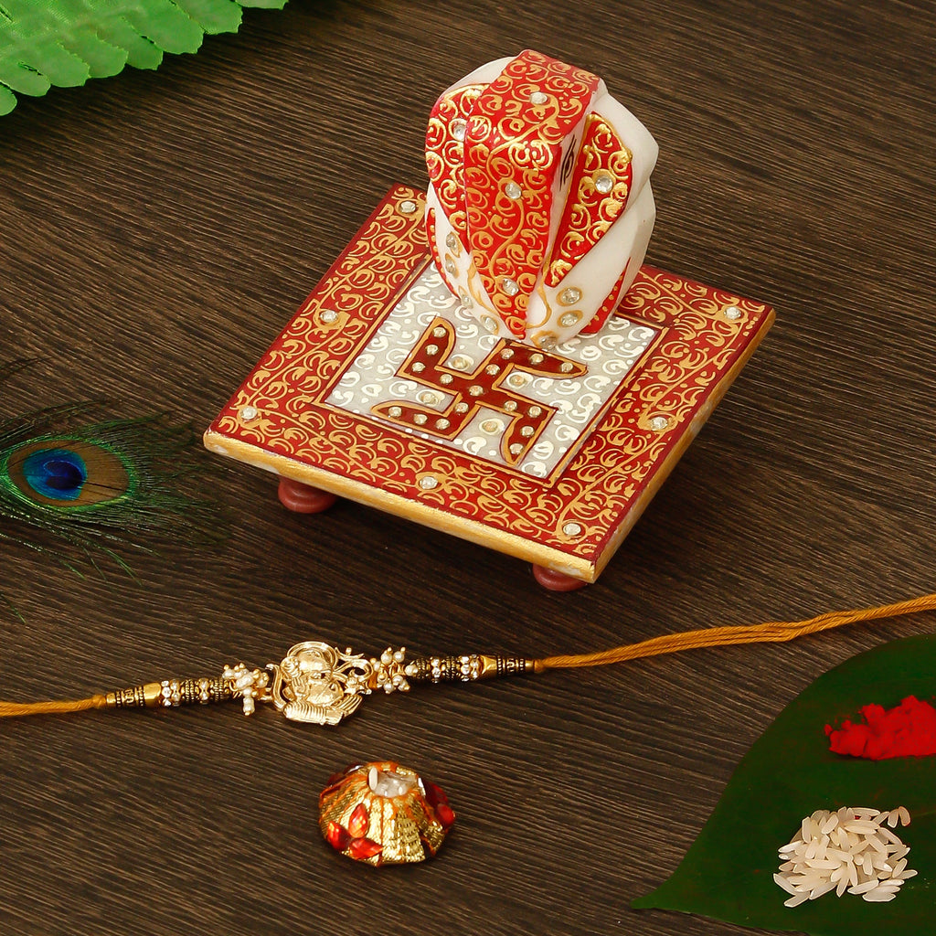 Designer Ganesha Rakhi with Ridhi Sidhi Marble chowki and Roli Tikka Matki Kafalo