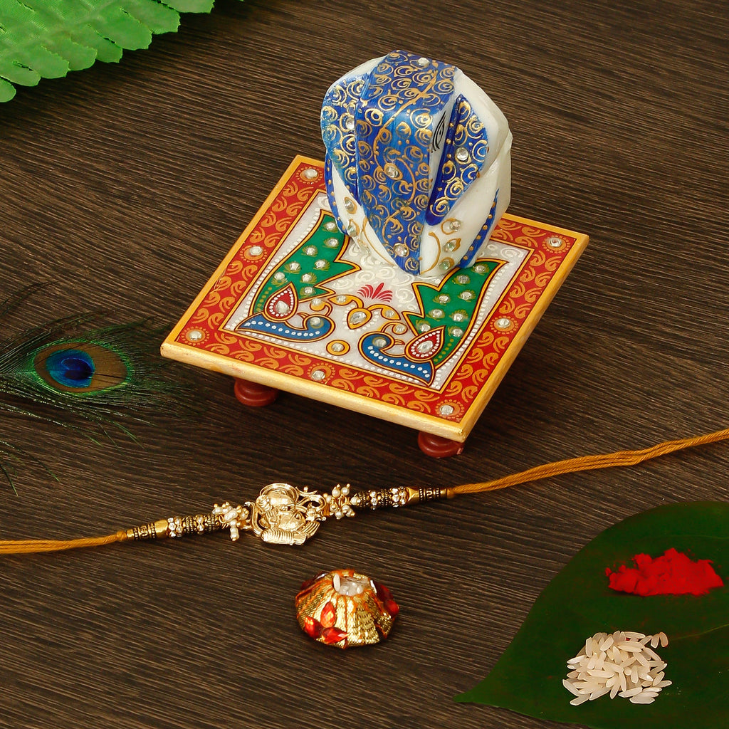 Designer Ganesha Rakhi with Lord Ganesha on Marble Chowki and Roli Tikka Matki Kafalo