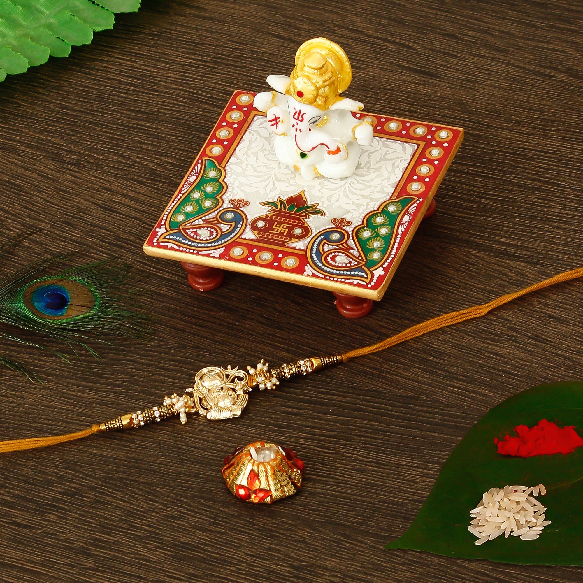 Designer Ganesha Rakhi with Lord Ganesha Marble Chowki and Roli Tikka Matki Kafalo