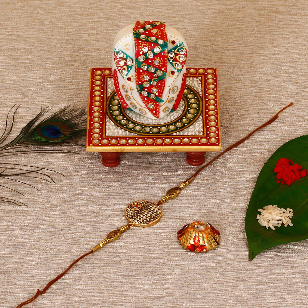 Designer Rakhi with Lord Ganesha on Kundan Studded Marble Chowki and Roli Tikka Matki Kafalo