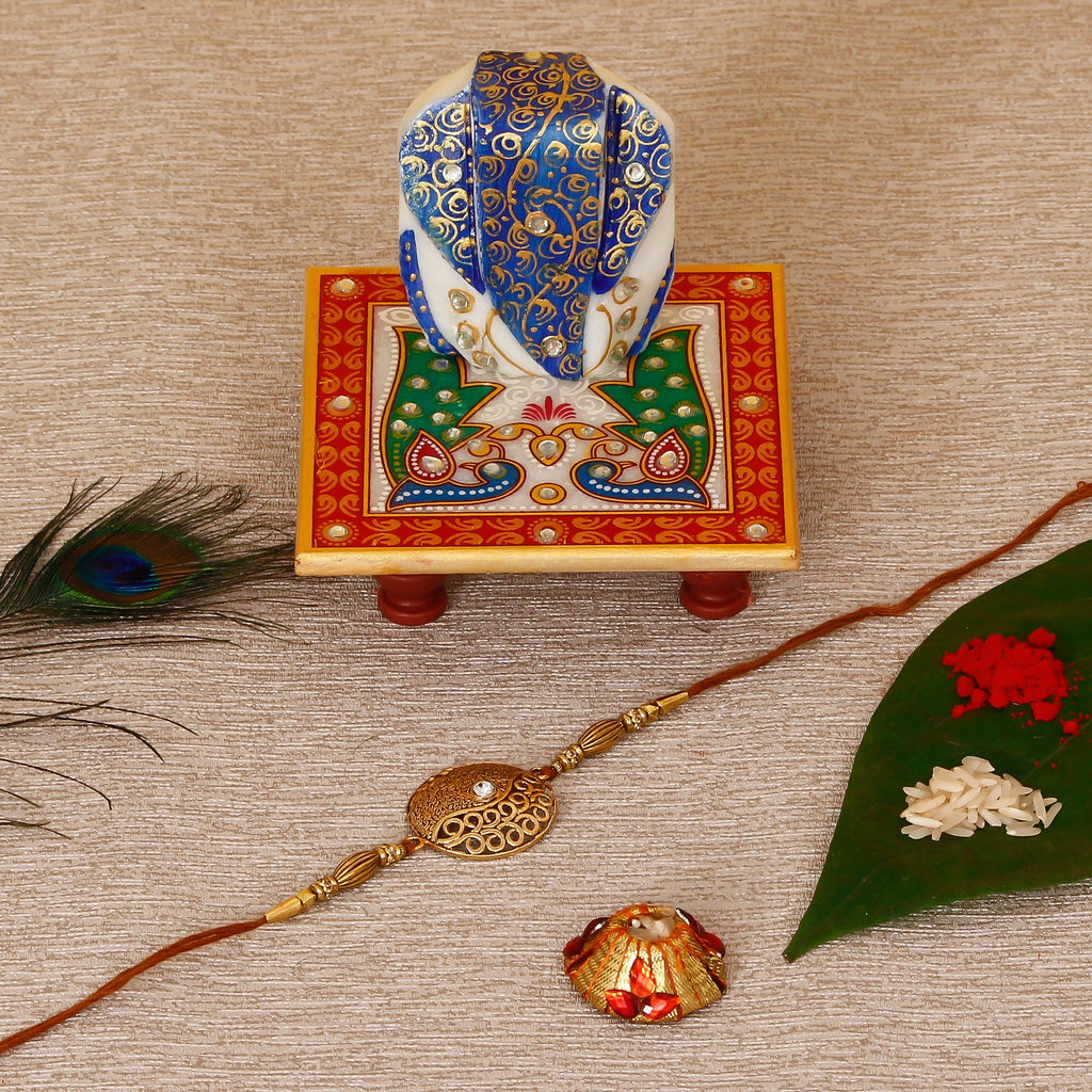Designer Rakhi with Lord Ganesha on Marble Chowki and Roli Tikka Matki Kafalo