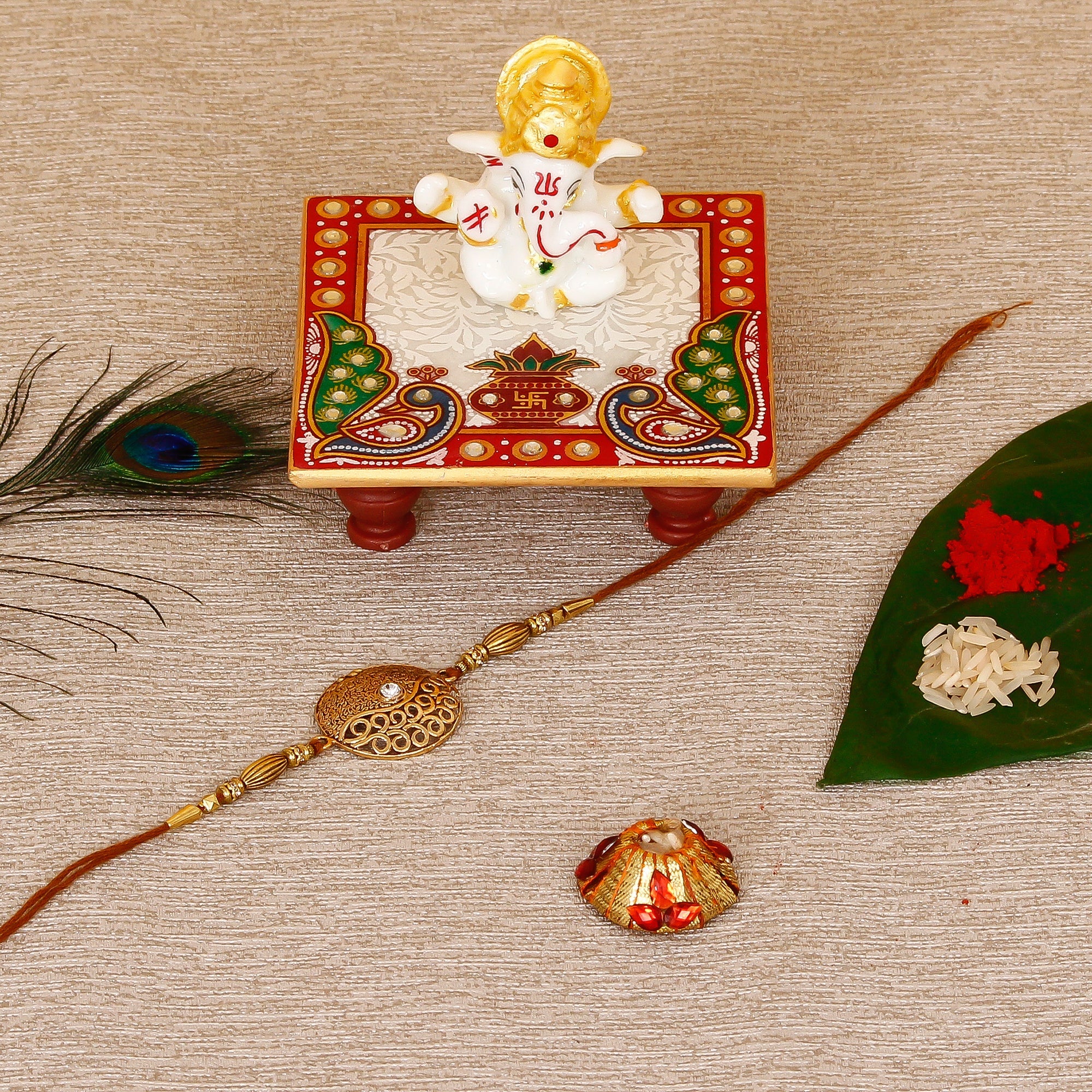 Designer Rakhi with Lord Ganesha Marble Chowki and Roli Tikka Matki Kafalo