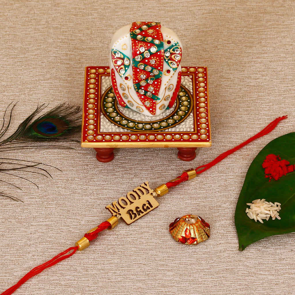 Designer Wooden Moddy Bhai Rakhi with Lord Ganesha on Kundan Studded Marble Chowki and Roli Tikka Matki Kafalo