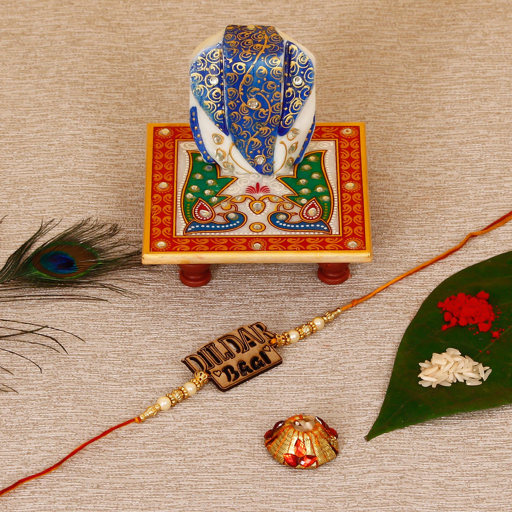 Designer Wooden Dildar Bhai Rakhi with Lord Ganesha on Marble Chowki and Roli Tikka Matki Kafalo