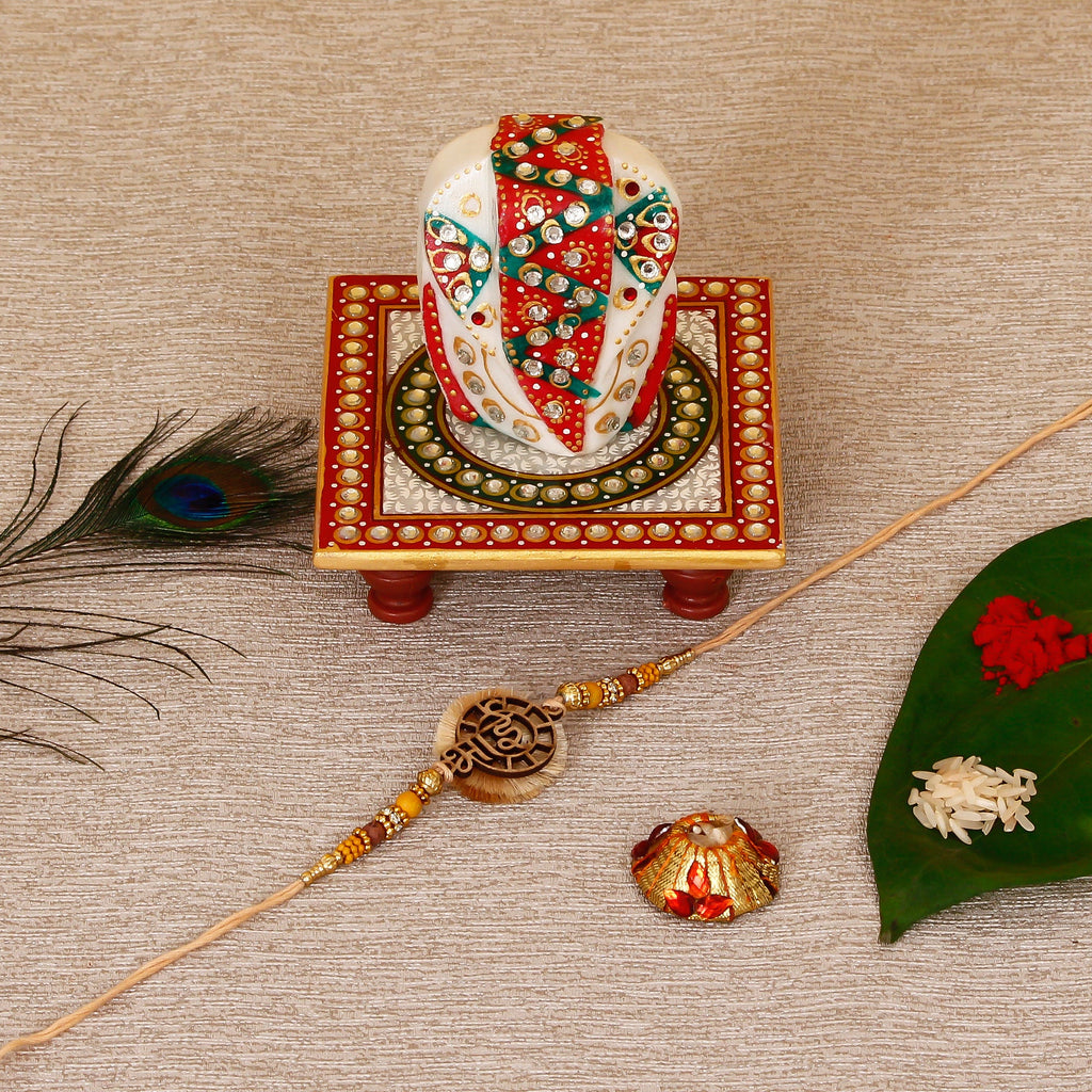 Designer Wooden Bhai Rakhi with Lord Ganesha on Kundan Studded Marble Chowki and Roli Tikka Matki Kafalo