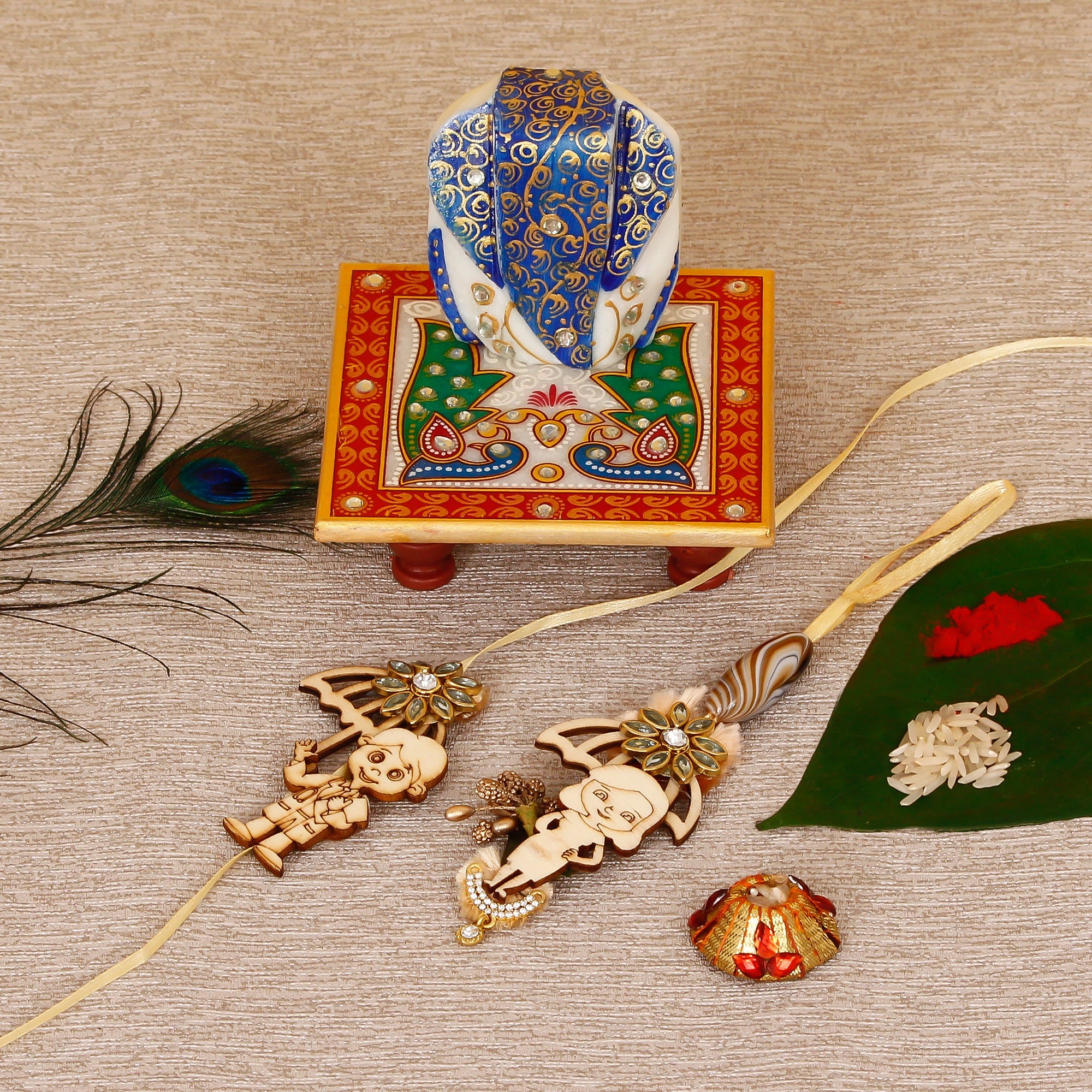 Designer Bhaiya Bhabhi Rakhi with Lord Ganesha on Marble Chowki and Roli Tikka Matki Kafalo