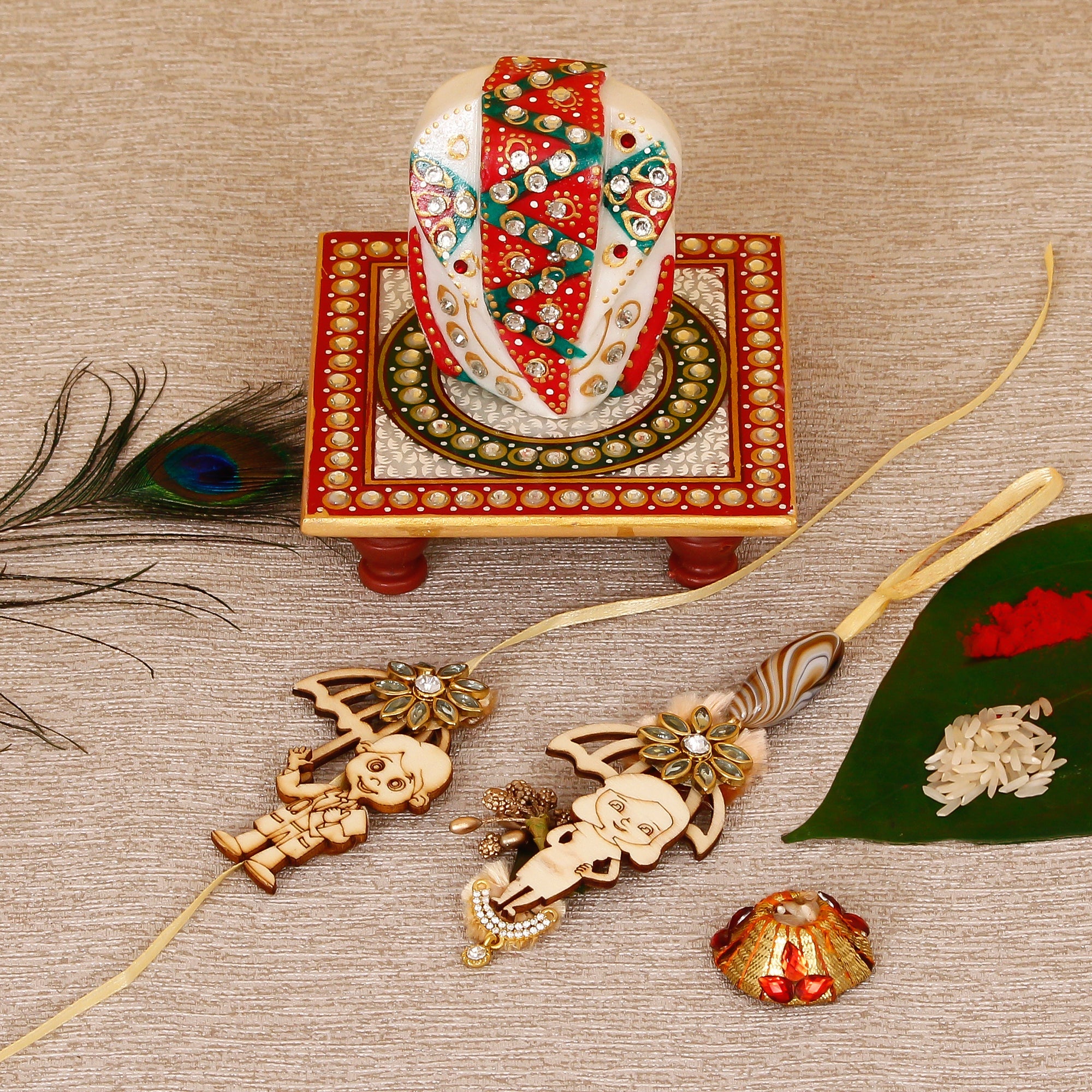 Designer Bhaiya Bhabhi Rakhi with Lord Ganesha on Kundan Studded Marble Chowki and Roli Tikka Matki Kafalo