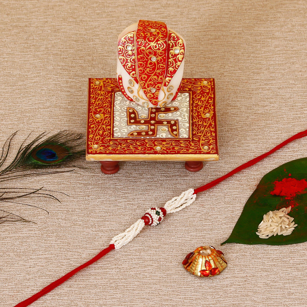 Designer Pearl Rakhi with Ridhi Sidhi Marble chowki and Roli Tikka Matki Kafalo
