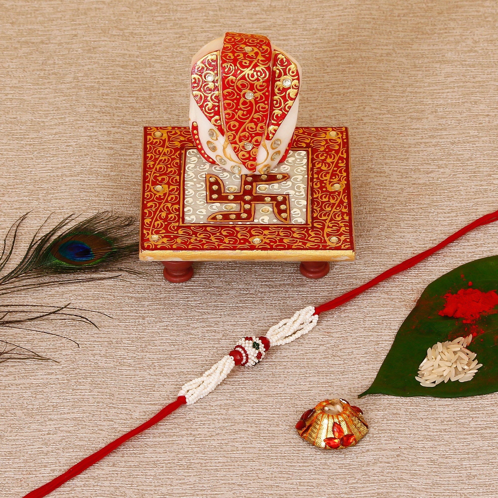 Designer Pearl Rakhi with Ridhi Sidhi Marble chowki and Roli Tikka Matki Kafalo