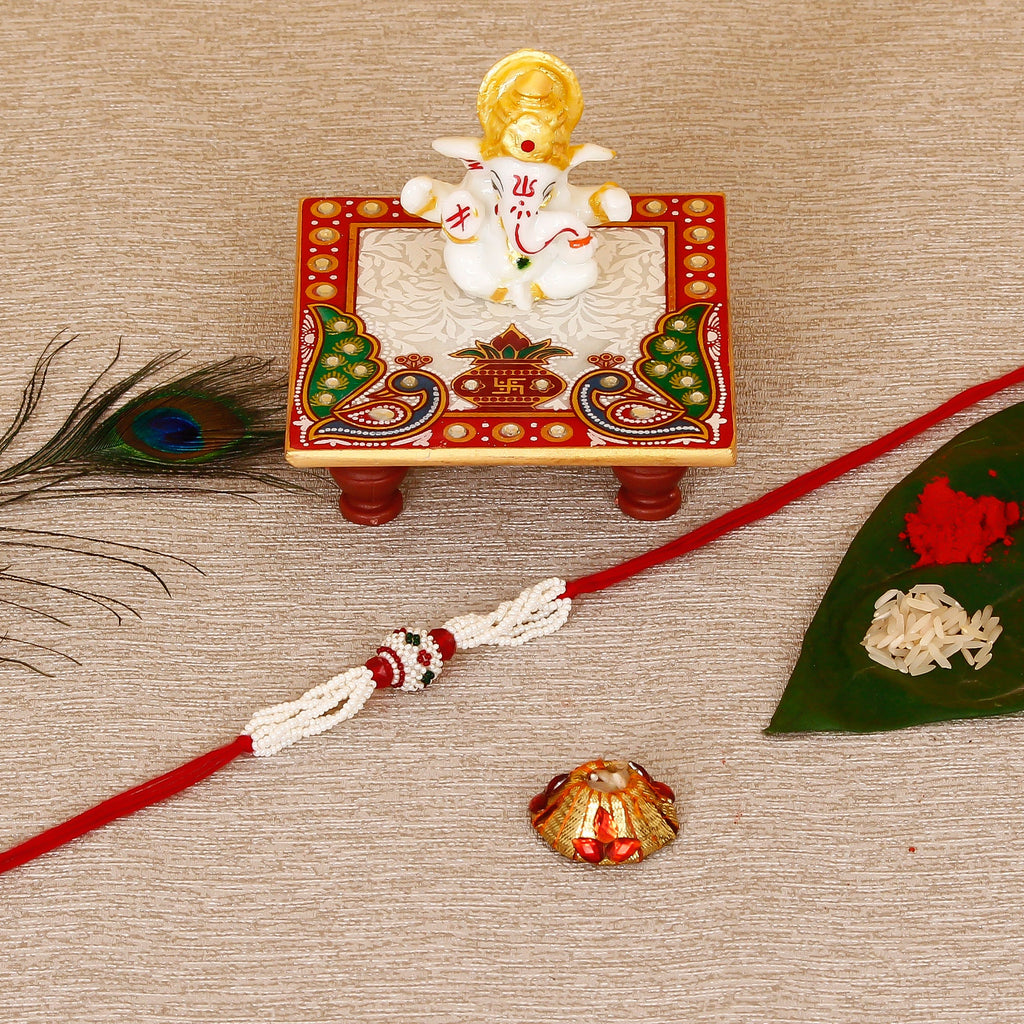 Designer Pearl Rakhi with Lord Ganesha Marble Chowki and Roli Tikka Matki Kafalo