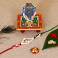 Designer Pearl Rakhi with Lord Ganesha on Marble Chowki and Roli Tikka Matki Kafalo