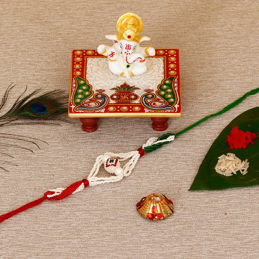 Designer Pearl Rakhi with Lord Ganesha Marble Chowki and Roli Tikka Matki Kafalo