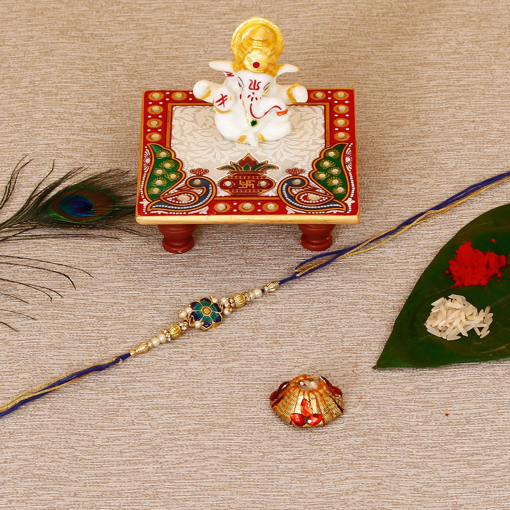 Designer Meenakari Rakhi with Lord Ganesha Marble Chowki and Roli Tikka Matki Kafalo
