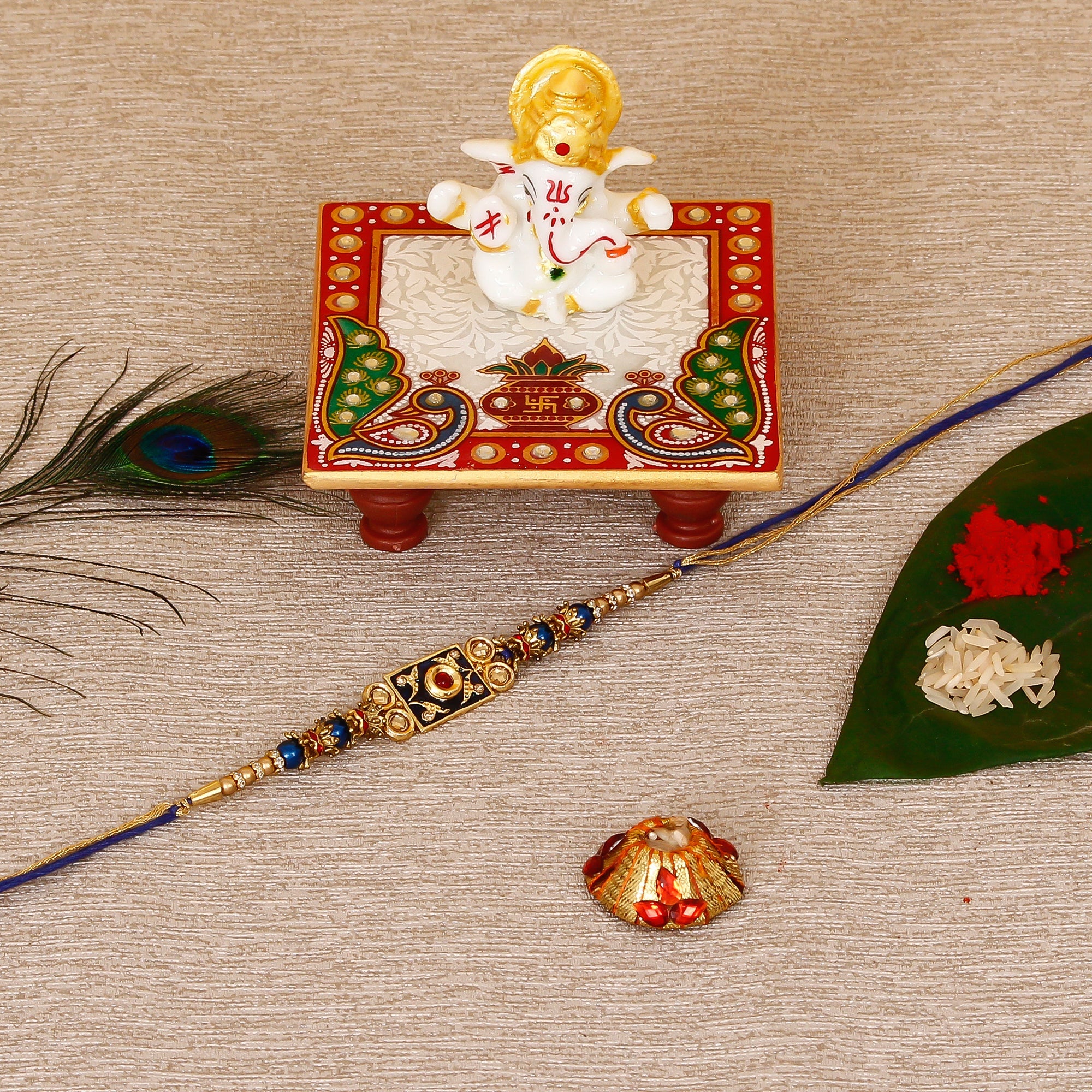 Designer Meenakari Rakhi with Lord Ganesha Marble Chowki and Roli Tikka Matki Kafalo