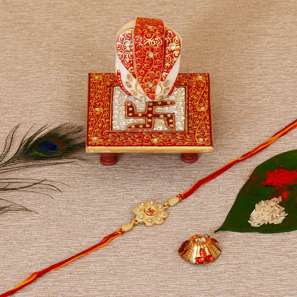 Designer Religious Swastik Rakhi with Ridhi Sidhi Marble chowki and Roli Tikka Matki Kafalo
