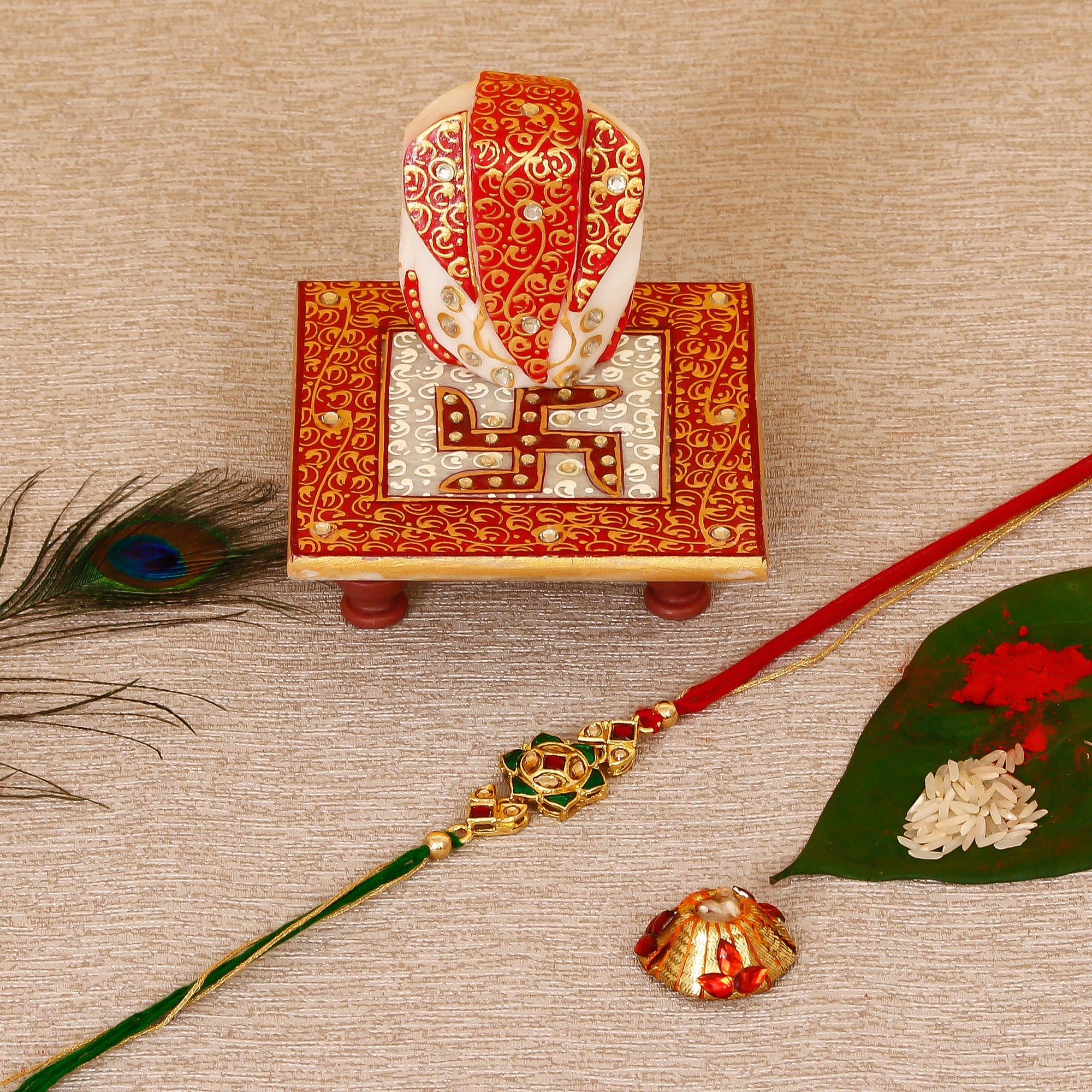 Designer Kundan Rakhi with Ridhi Sidhi Marble chowki and Roli Tikka Matki Kafalo