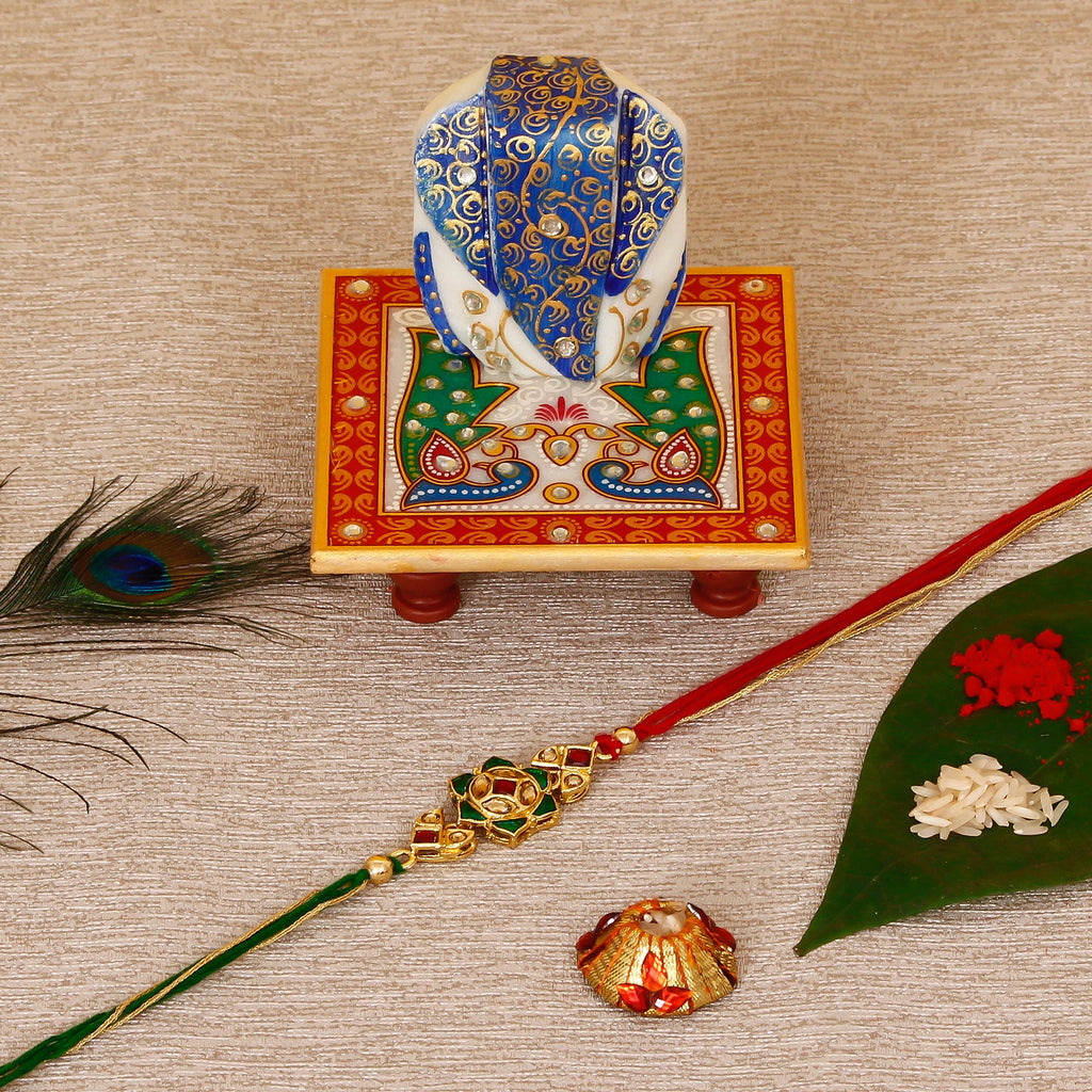 Designer Kundan Rakhi with Lord Ganesha on Marble Chowki and Roli Tikka Matki Kafalo