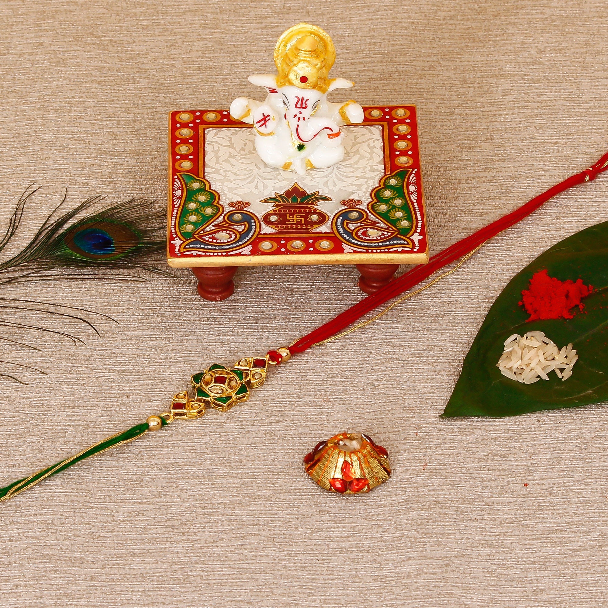 Designer Kundan Rakhi with Lord Ganesha Marble Chowki and Roli Tikka Matki Kafalo