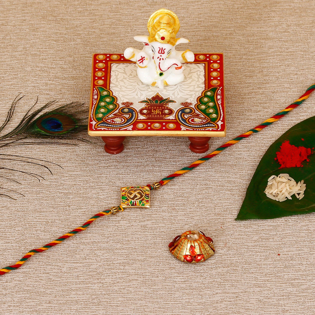 Designer Religious Swastik Rakhi with Lord Ganesha Marble Chowki and Roli Tikka Matki Kafalo