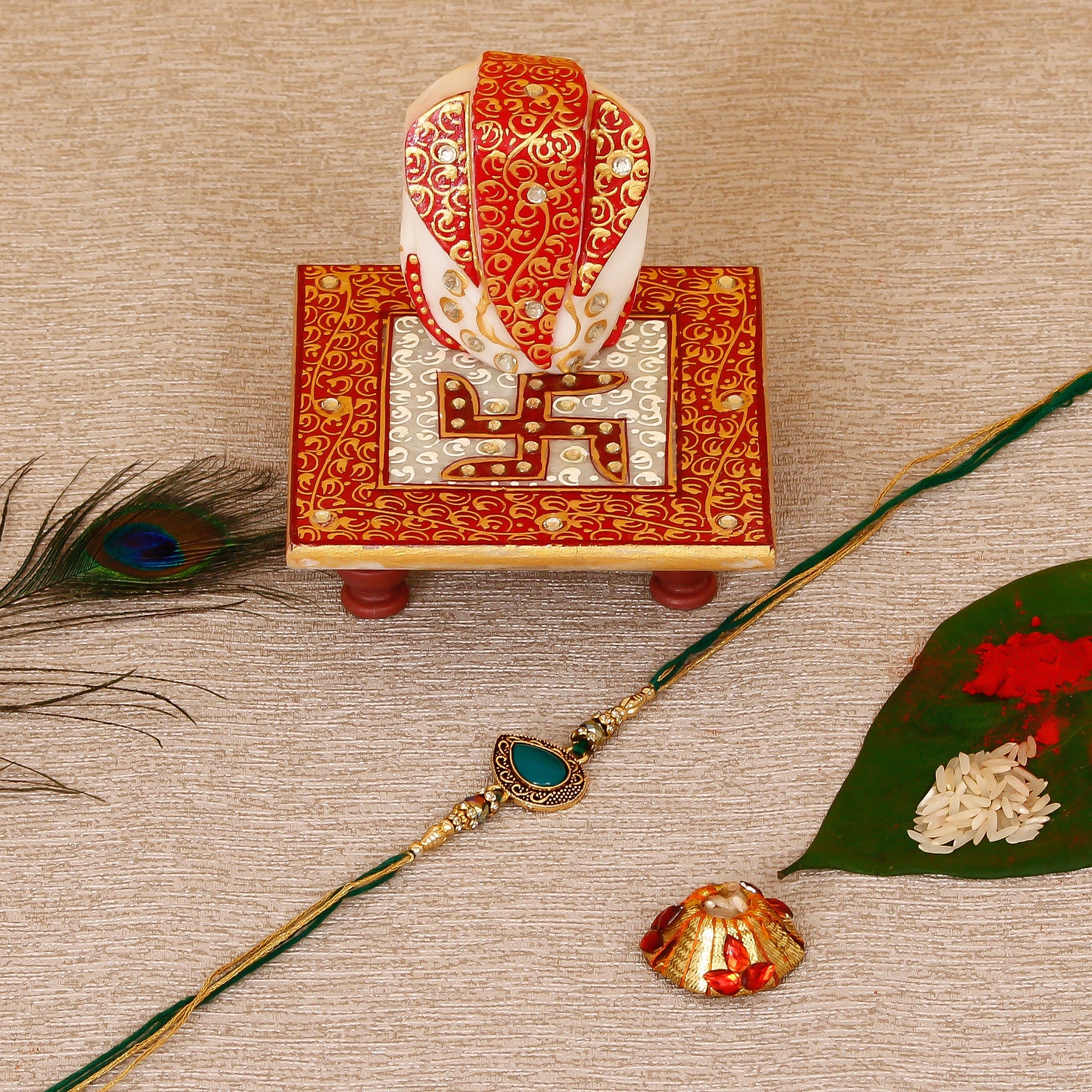 Designer Stone Rakhi with Ridhi Sidhi Marble chowki and Roli Tikka Matki Kafalo