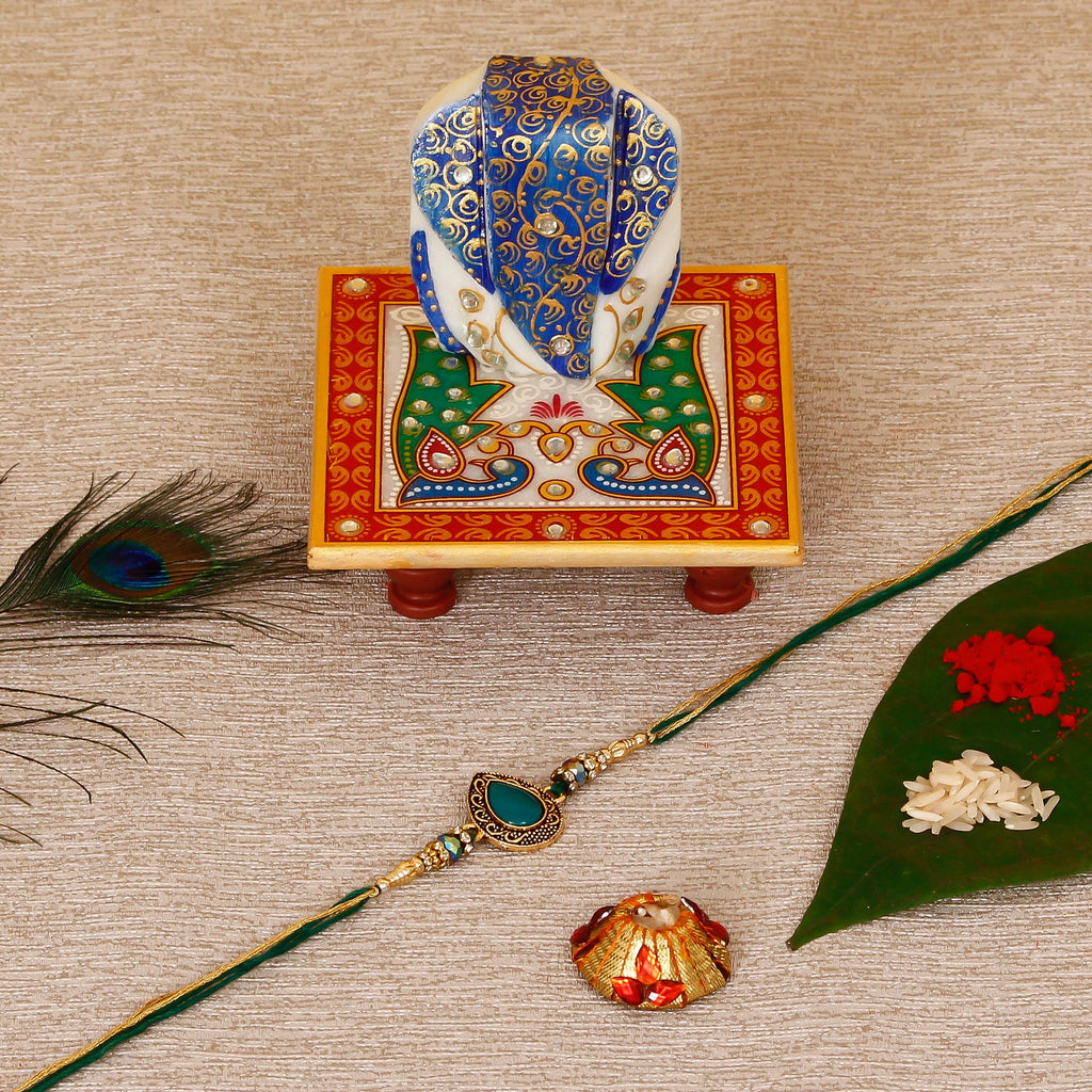 Designer Stone Rakhi with Lord Ganesha on Marble Chowki and Roli Tikka Matki Kafalo