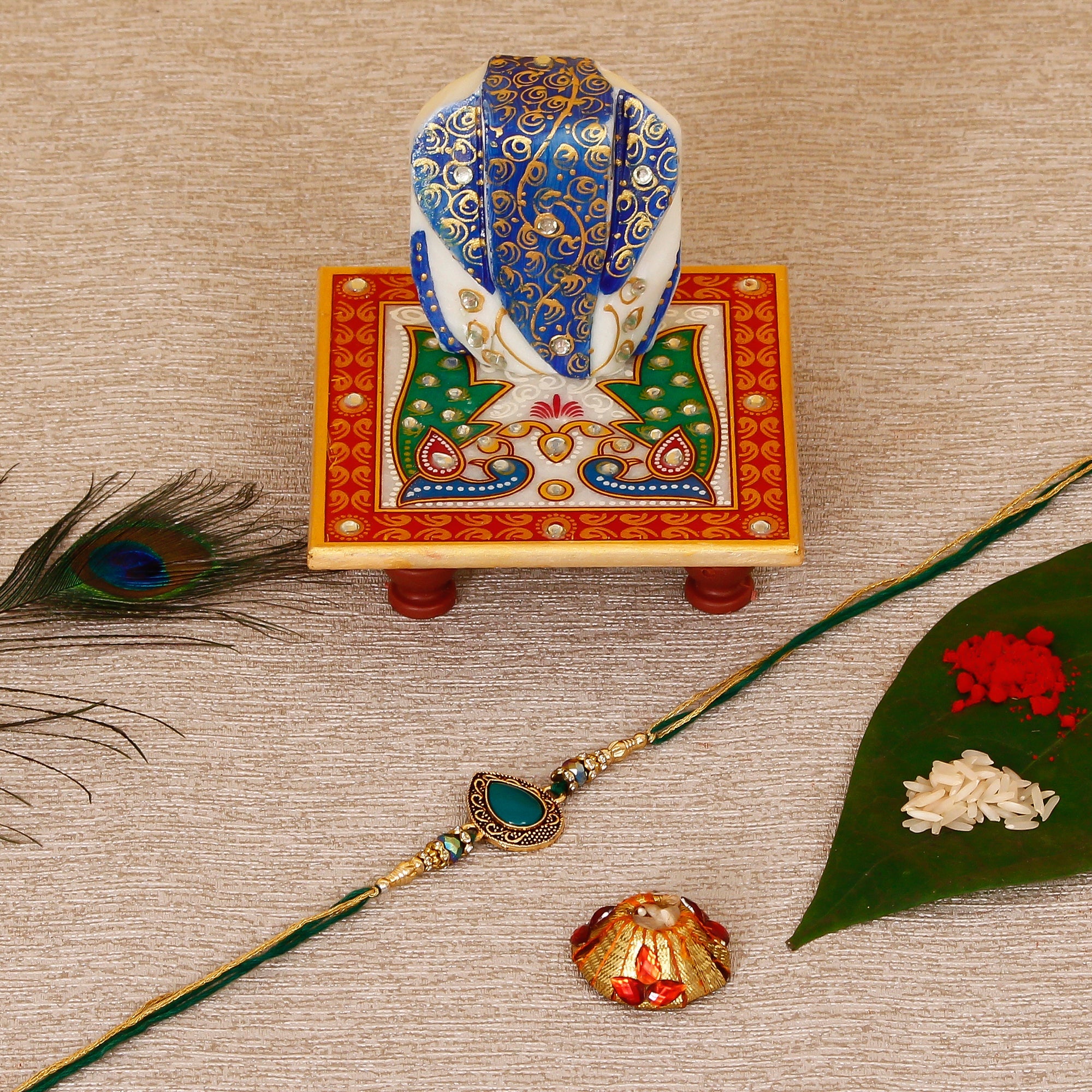Designer Stone Rakhi with Lord Ganesha on Marble Chowki and Roli Tikka Matki Kafalo