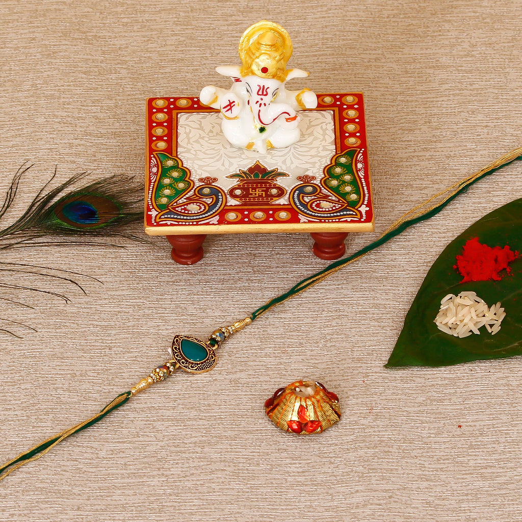Designer Stone Rakhi with Lord Ganesha Marble Chowki and Roli Tikka Matki Kafalo