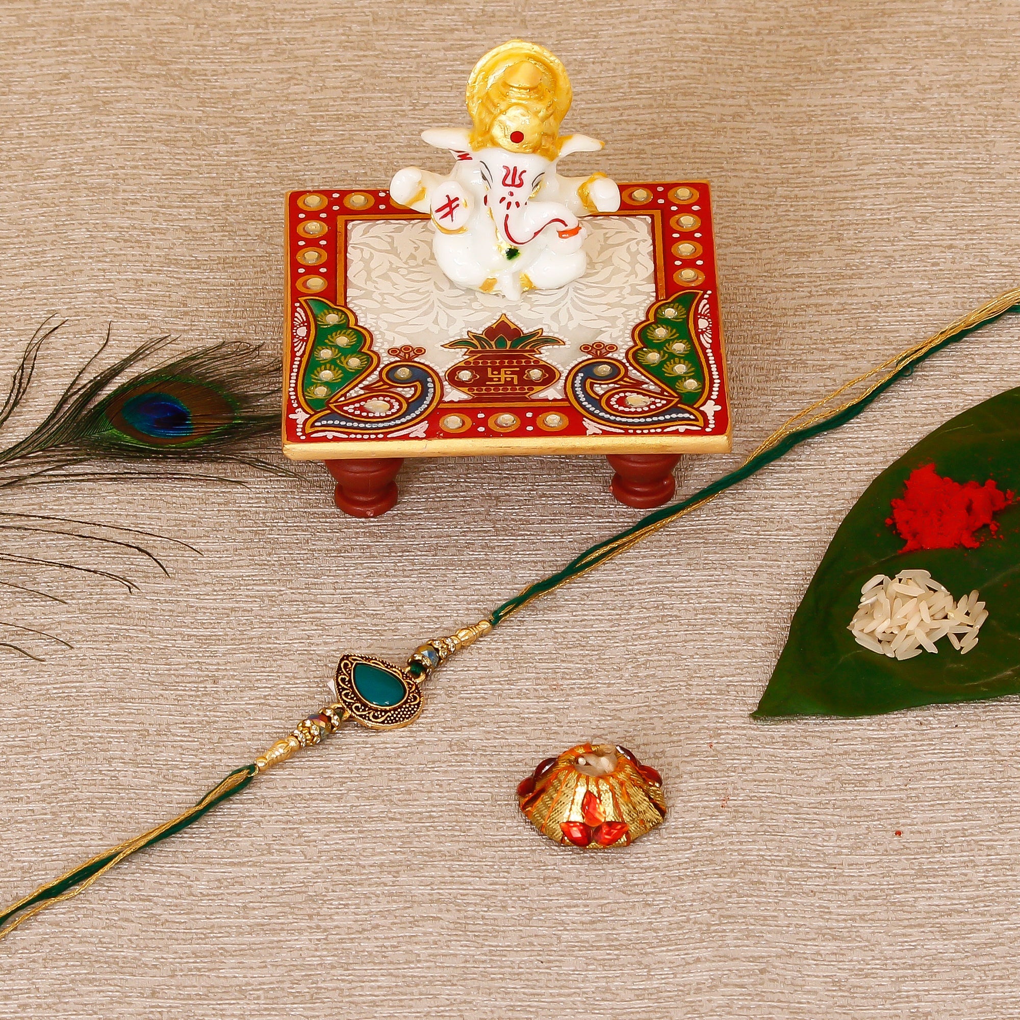 Designer Stone Rakhi with Lord Ganesha Marble Chowki and Roli Tikka Matki Kafalo