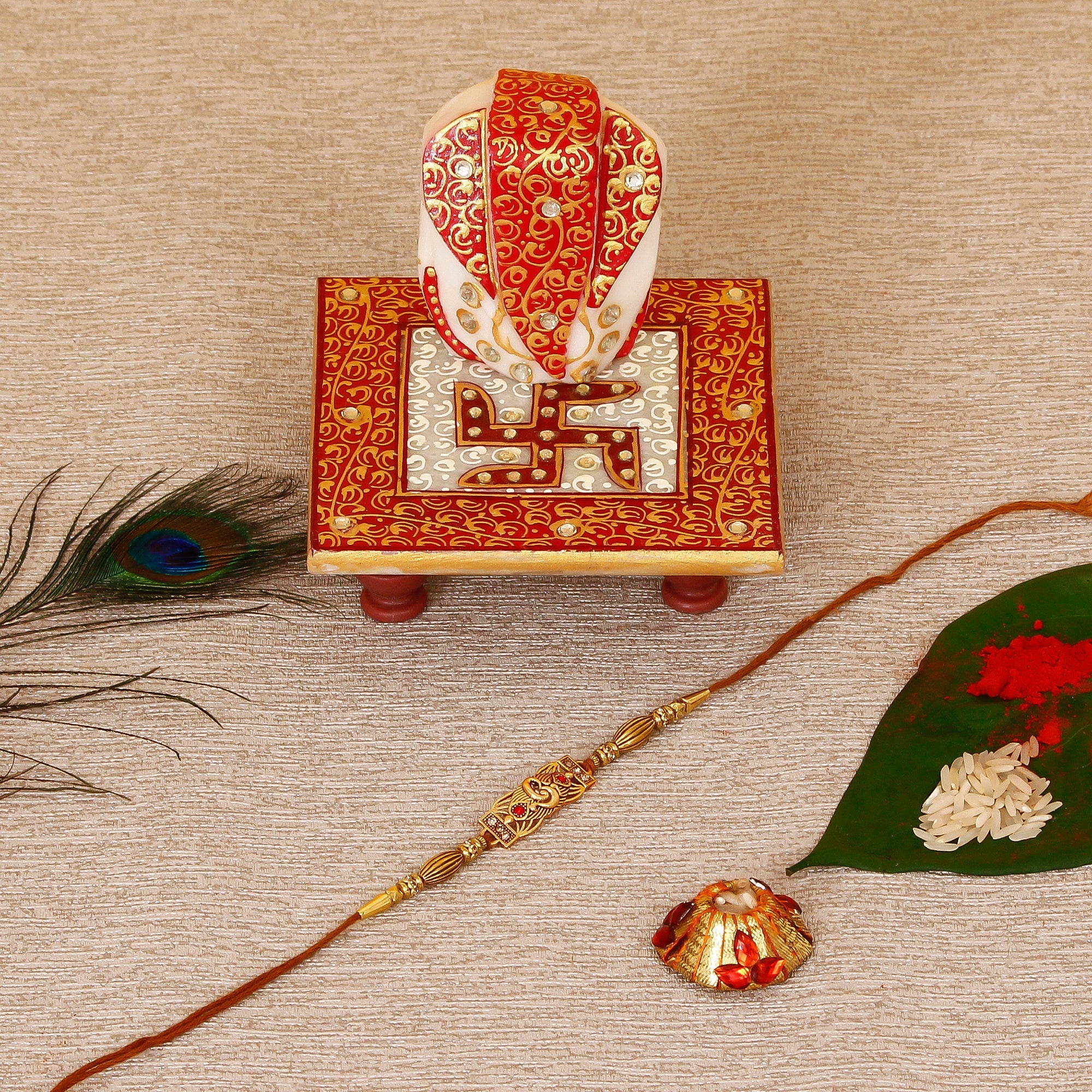Designer Religious Rakhi with Ridhi Sidhi Marble chowki and Roli Tikka Matki Kafalo