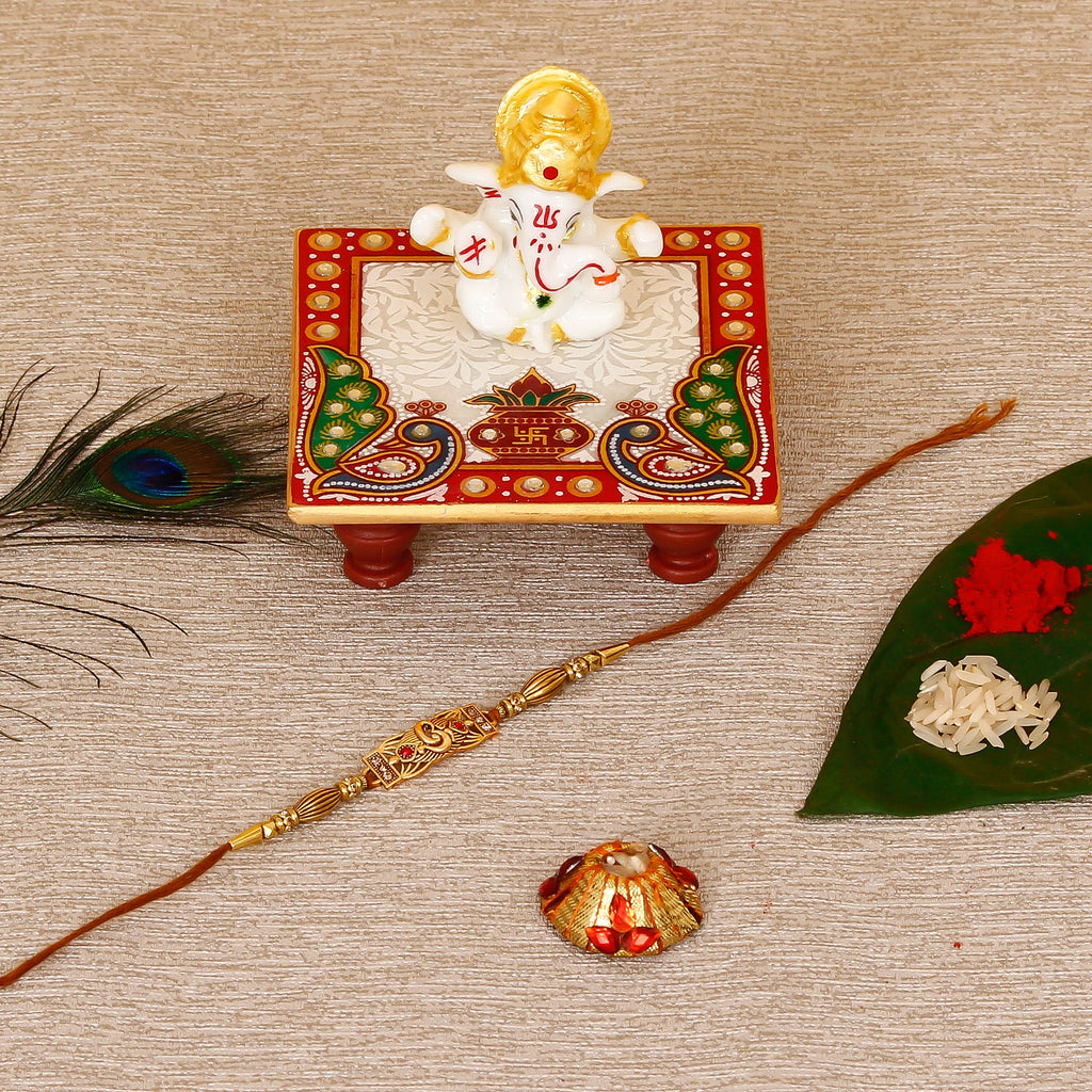 Designer Religious Rakhi with Lord Ganesha Marble Chowki and Roli Tikka Matki Kafalo