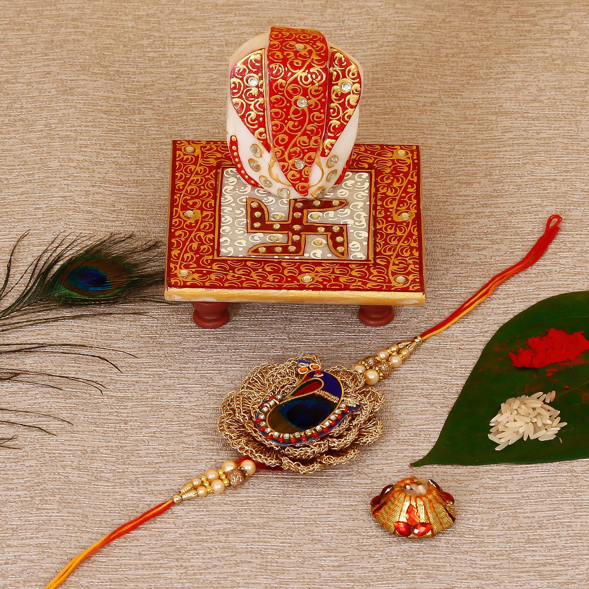 Designer Peacock Rakhi with Ridhi Sidhi Marble chowki and Roli Tikka Matki Kafalo