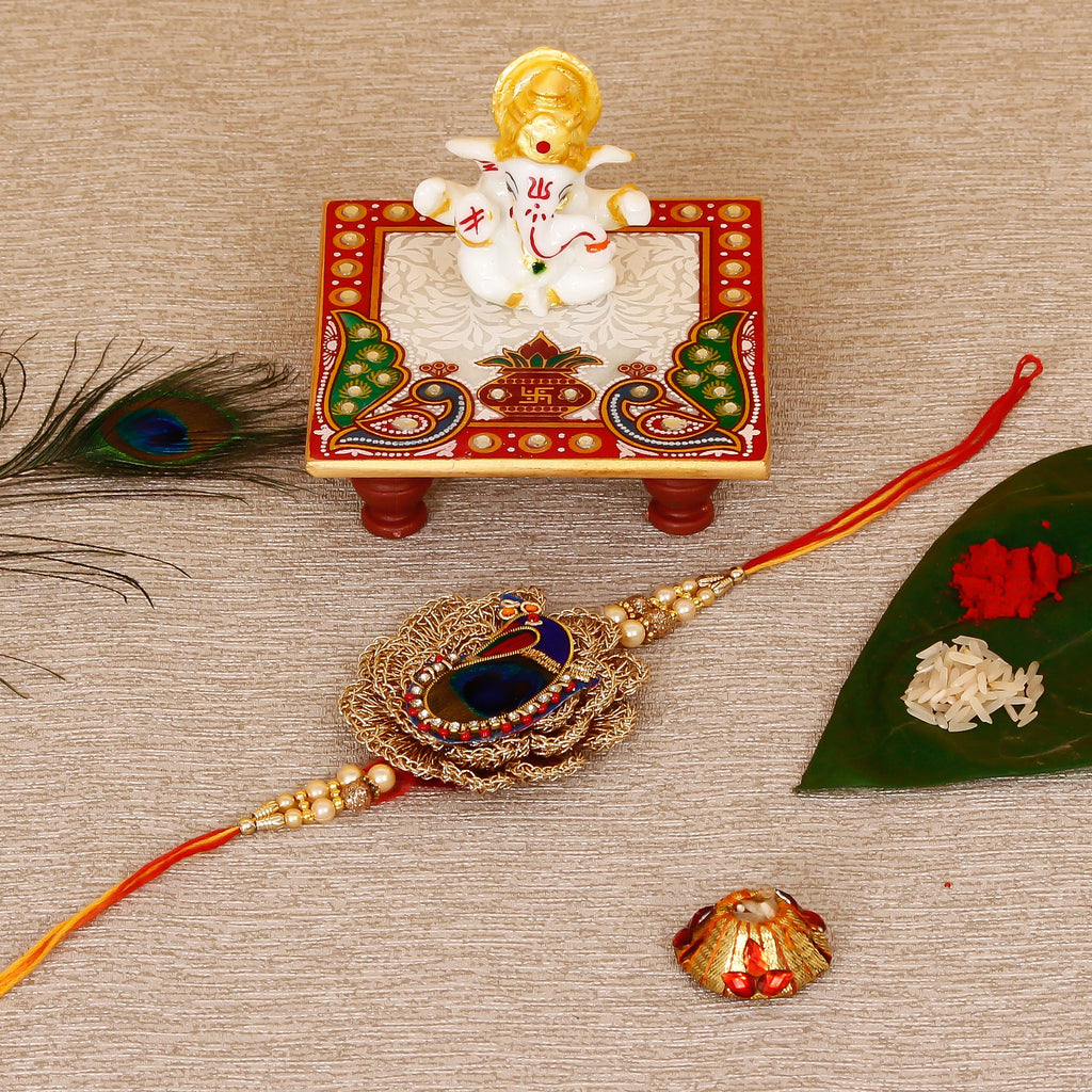 Designer Peacock Rakhi with Lord Ganesha Marble Chowki and Roli Tikka Matki Kafalo