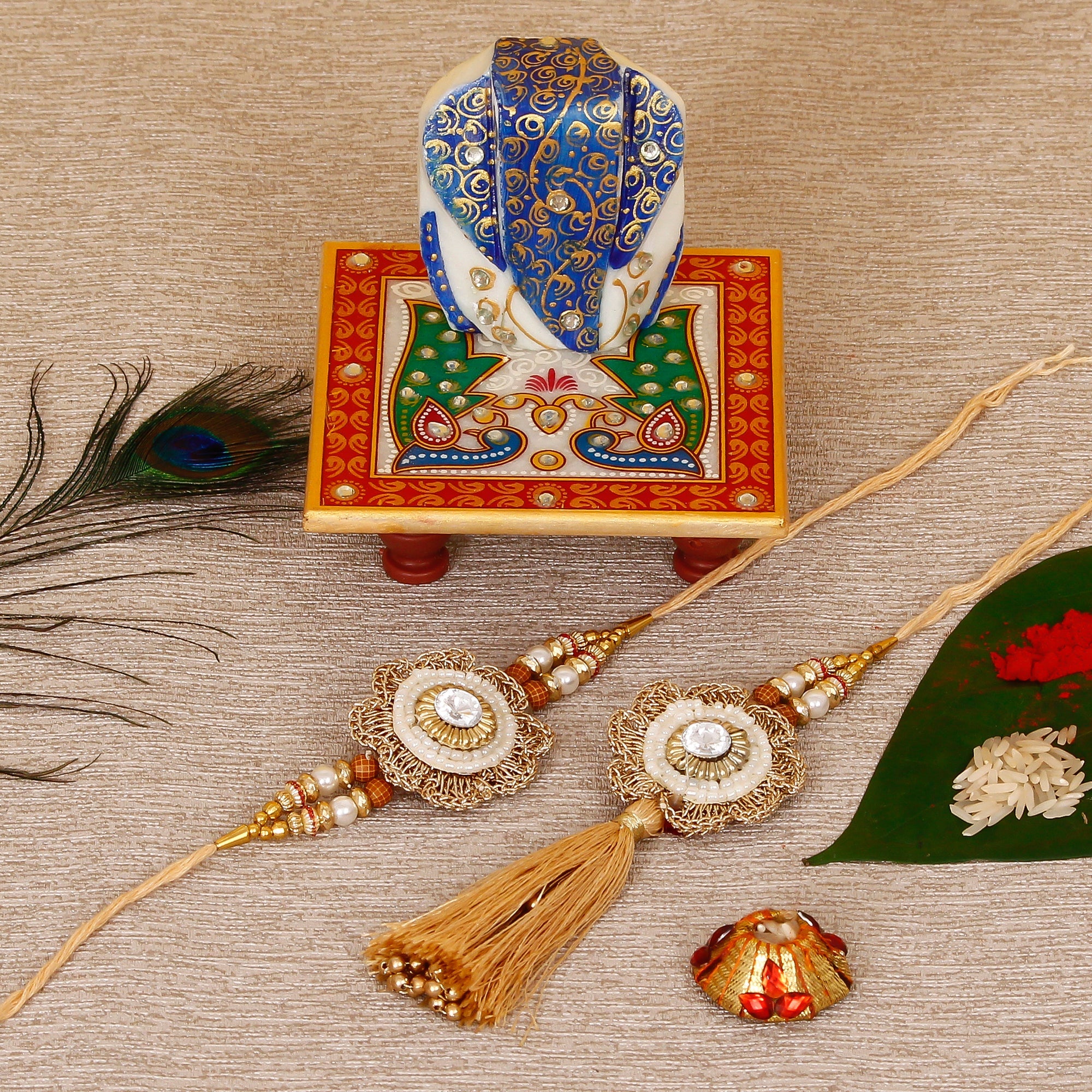 Designer Bhaiya Bhabhi Rakhi with Lord Ganesha on Marble Chowki and Roli Tikka Matki Kafalo
