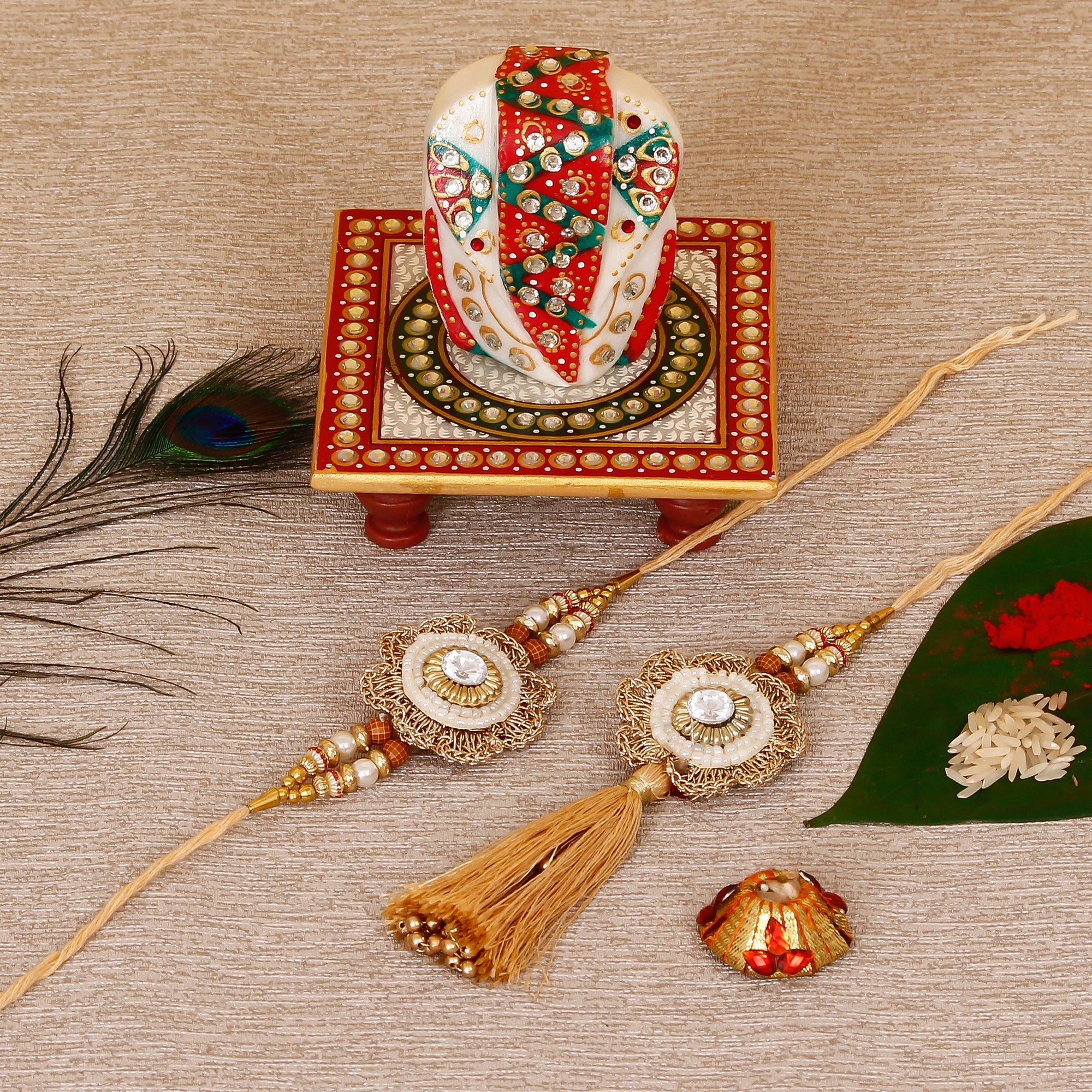 Designer Bhaiya Bhabhi Rakhi with Lord Ganesha on Kundan Studded Marble Chowki and Roli Tikka Matki Kafalo